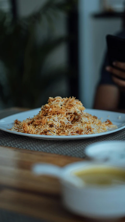 a plate of shredded cheese on a table