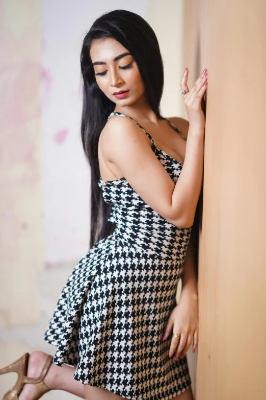 beautiful young woman in black and white dress posing for the camera