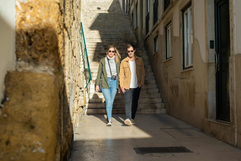 two women walking up some stairs in the city