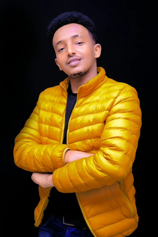 an african american male in a yellow puffy jacket