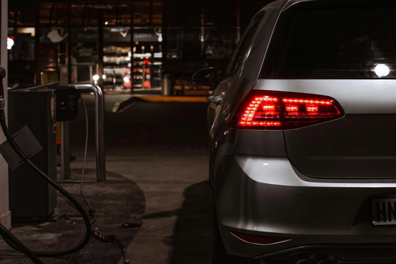 a car is plugged in to a gas pump