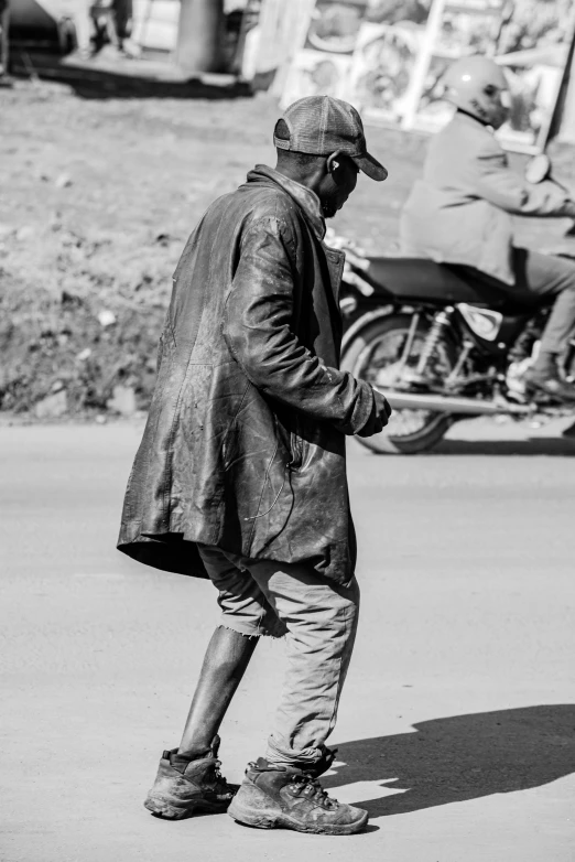 a man that is standing on the street