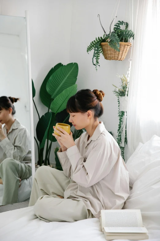 a woman is sitting down reading while eating food