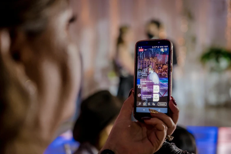 woman taking a pograph of a music concert with a phone