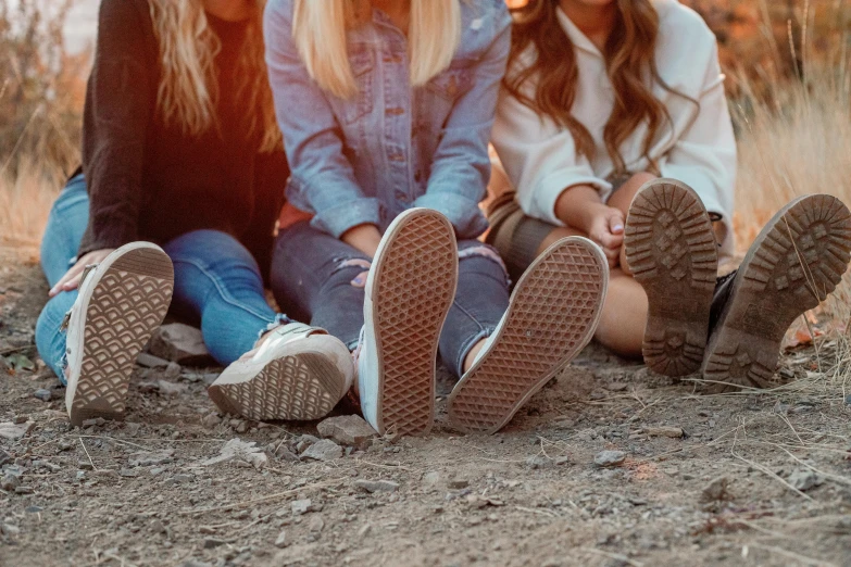 two s sitting on ground talking and laughing