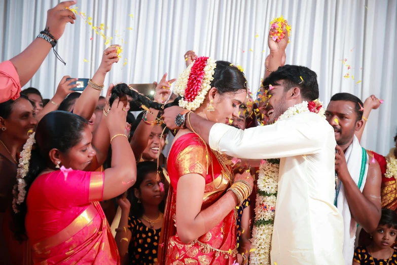 the bride and groom kiss as they enter the wedding ceremony