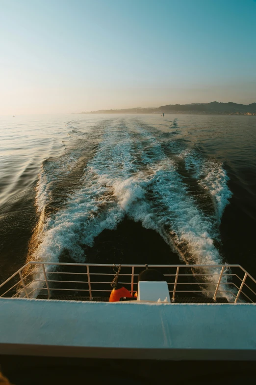 the wake of a boat behind a boat in the ocean