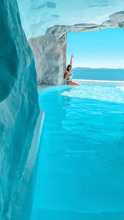 woman standing by water with a pool between two walls