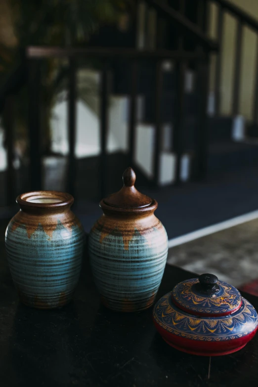 two blue and white containers on top of a table