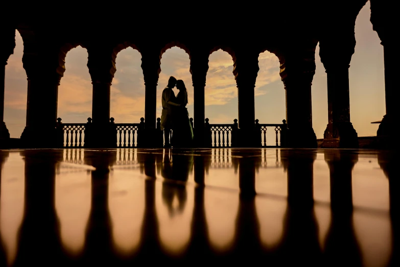 couple standing in an abandoned building by pillars