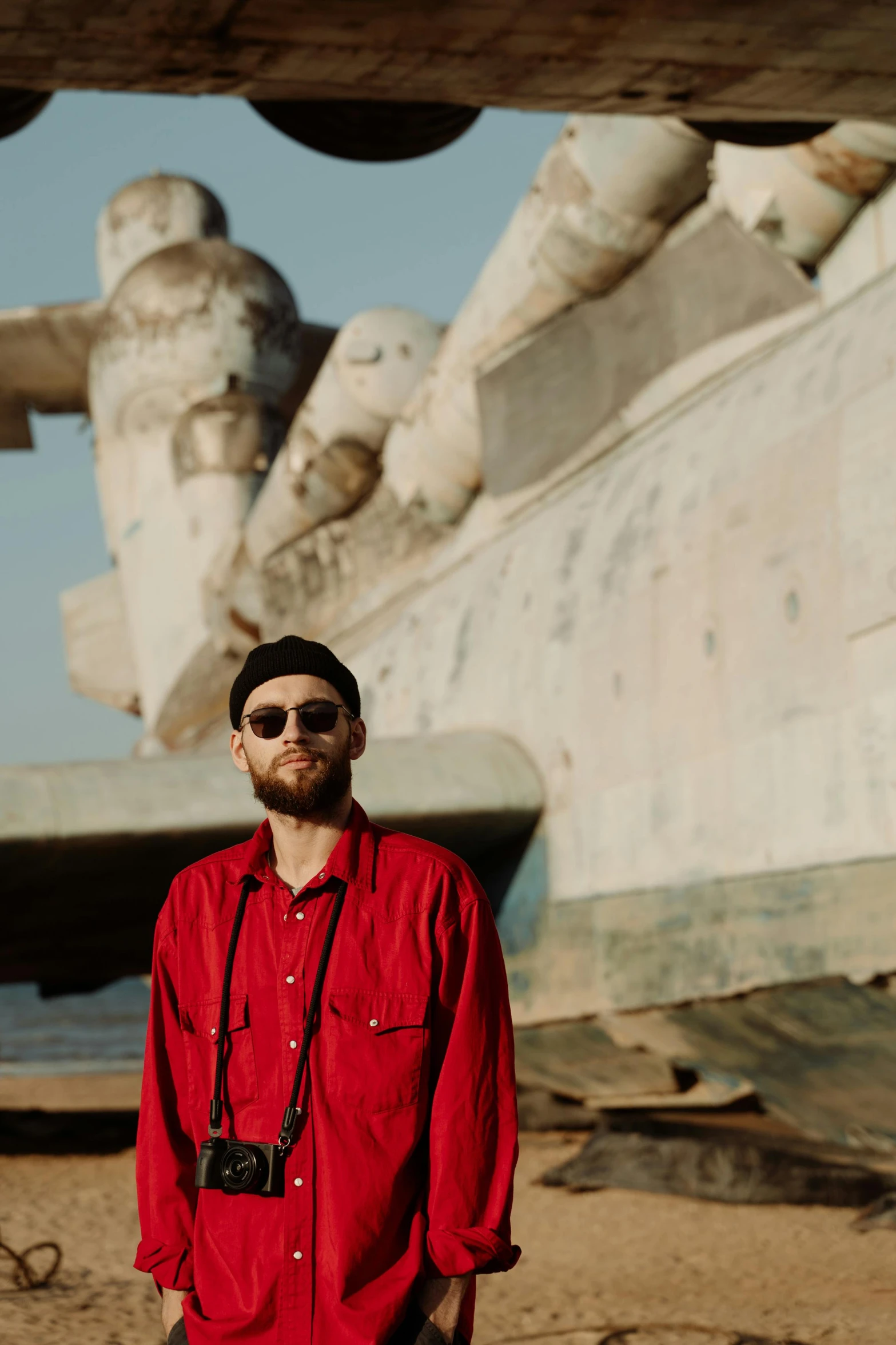 a man in a red shirt looking up to the sky