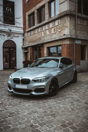 bmw car parked in front of a brick building