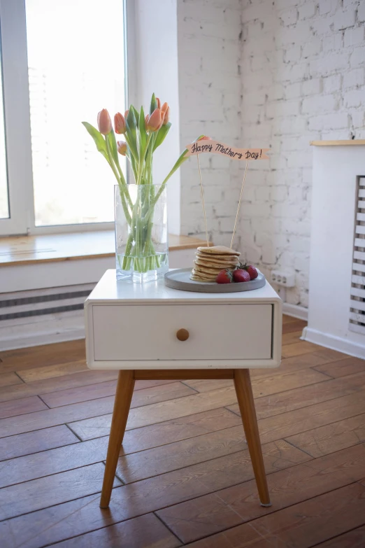 two flowers and some cake on a coffee table