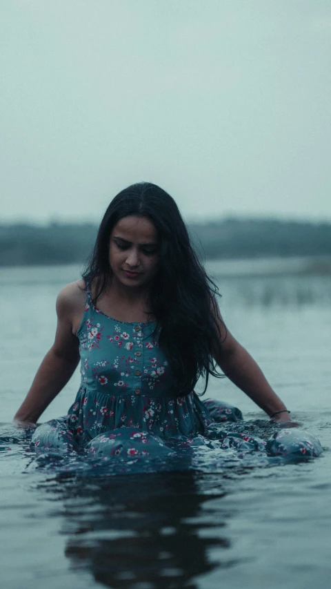 a girl standing in the water with her head back