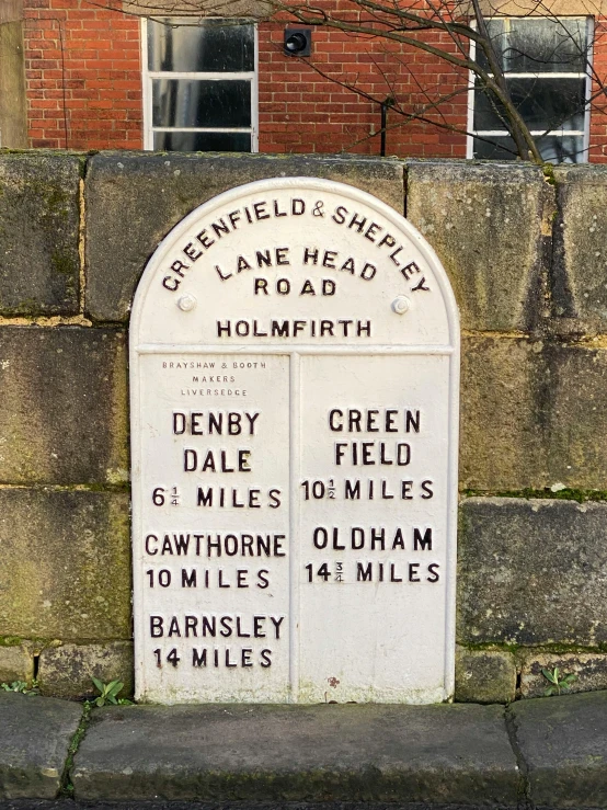 a memorial wall that has two small plaques on it