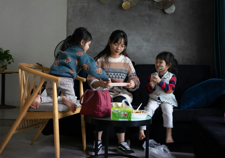 a group of s sit around together on chairs