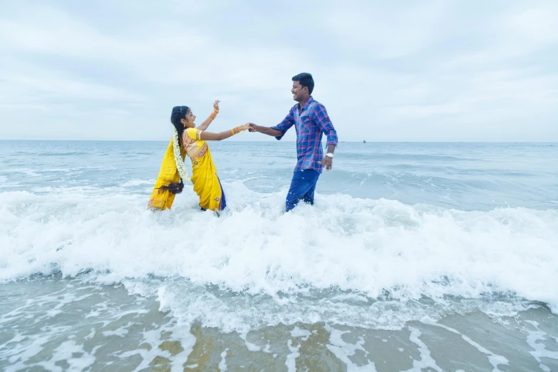 a man and woman are holding hands in the water