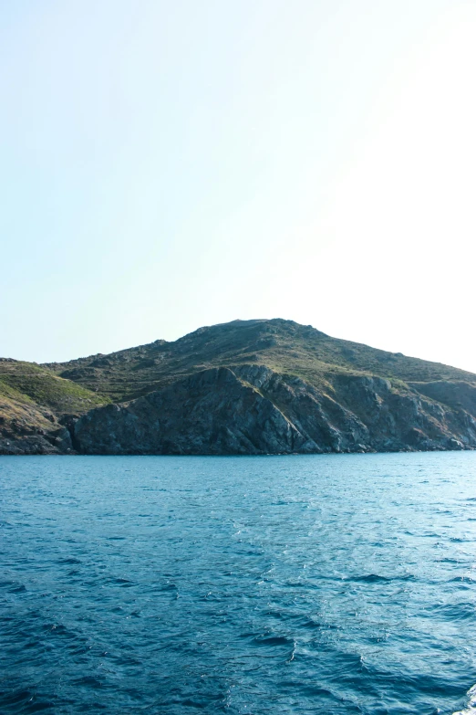 a rocky hillside on a clear day on a boat