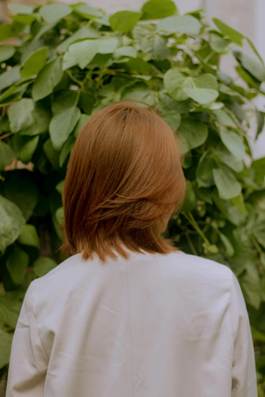 a woman with red hair and white blouse