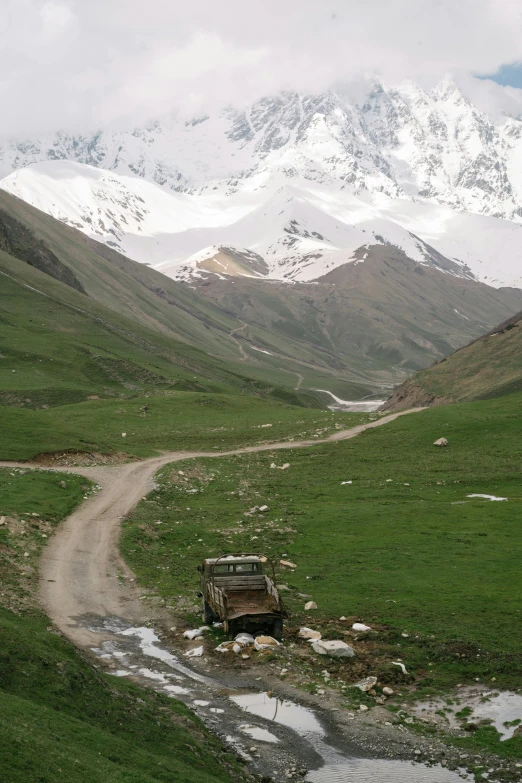 a car in the mountains going through a dle of water