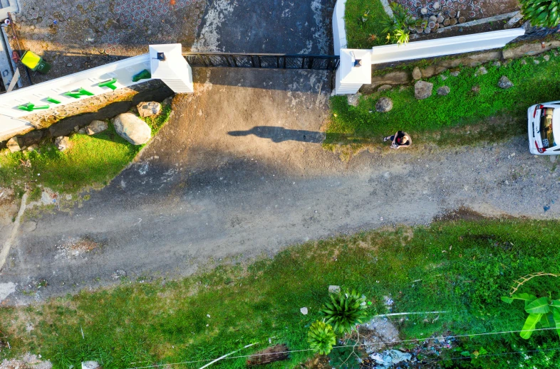 two small children on skateboards near a ramp and grass