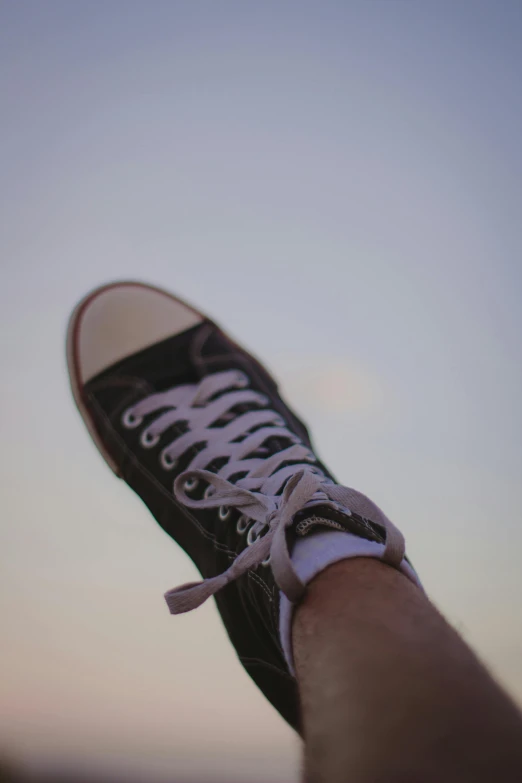 someone has taken a picture of their feet with a shoelace