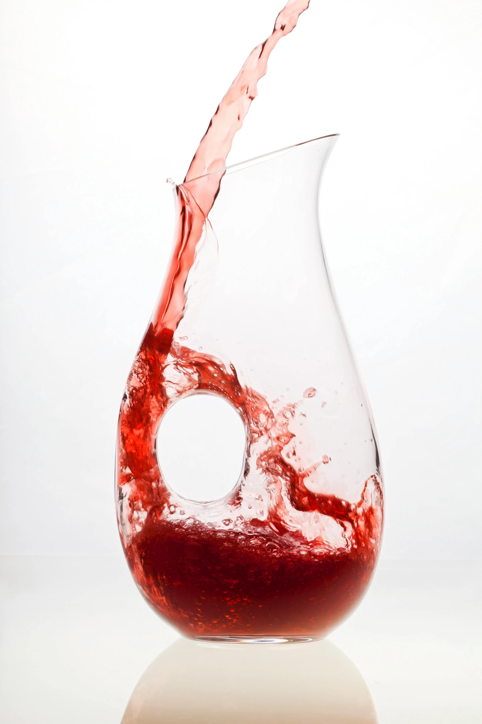 a wine glass with some red liquid in it