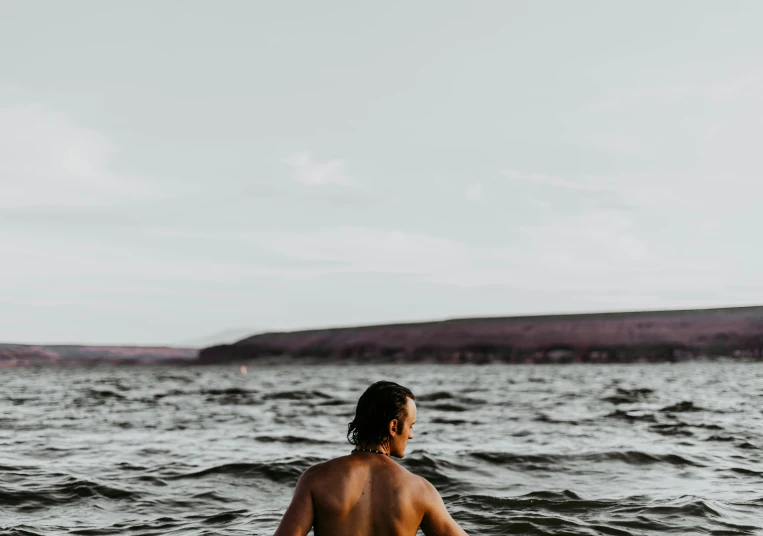 a man sitting in a canoe in a body of water