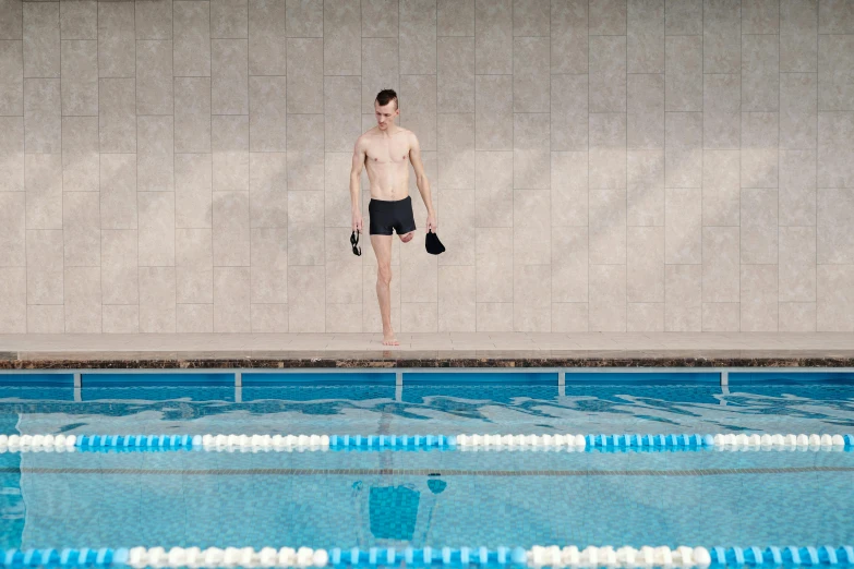 the young swimmer is ready for his swim