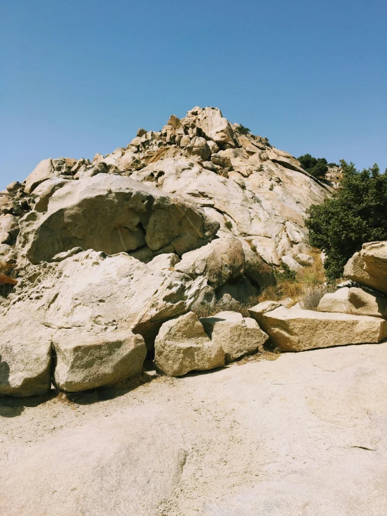 a rocky outcrop is shown against a blue sky