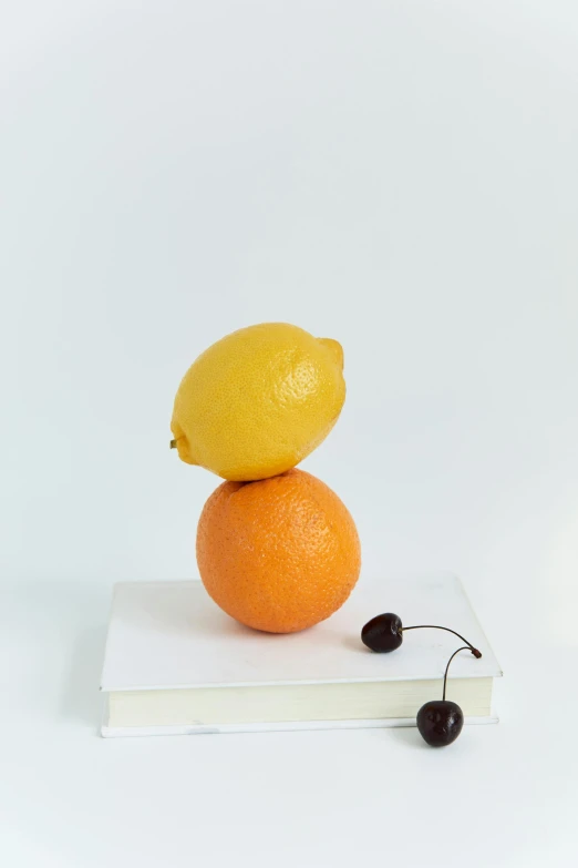 the lemon is sitting on an orange slice