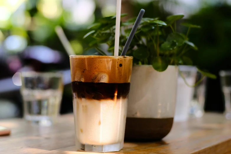 a coffee is placed on a table with two cups