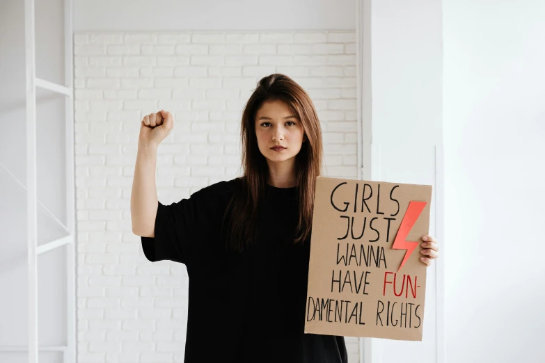 a woman holding a sign that says girls just haven to have fun national record