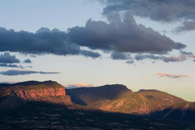 the sun rises over the mountains below