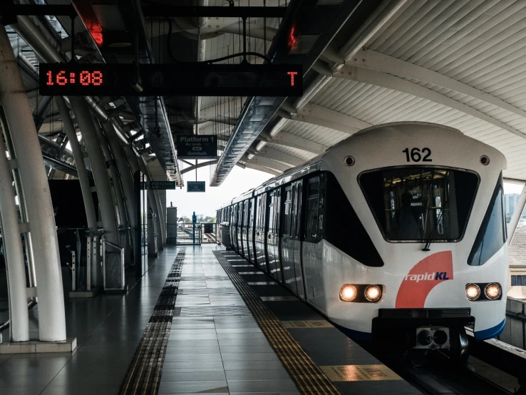 a passenger train pulling into a train station