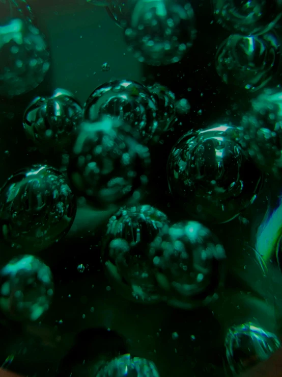 some green colored glass balls in some water