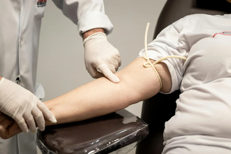 a doctor putting a bandage on the arm of a patient