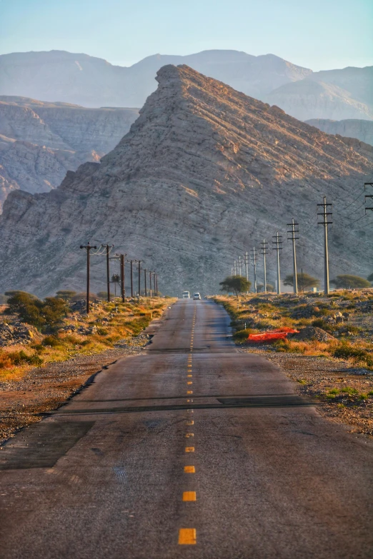 a road with power lines and poles along it