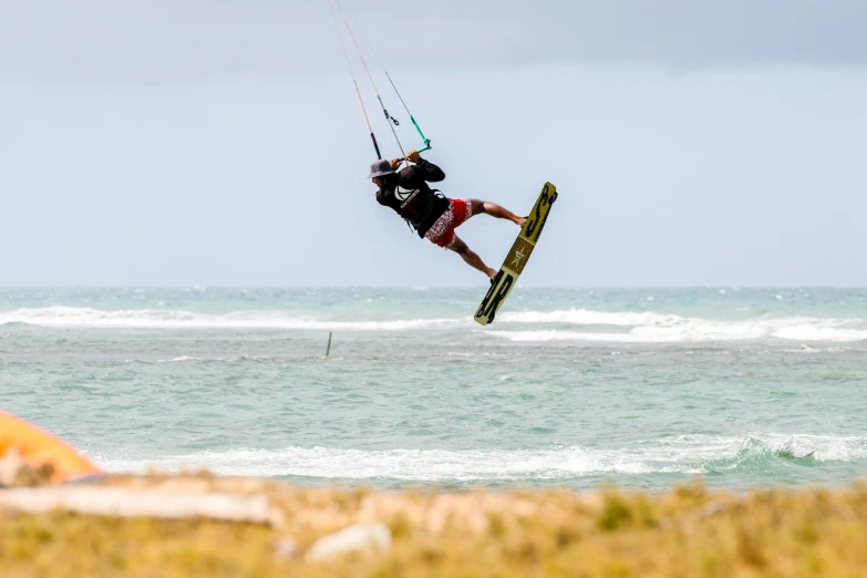 a man on a board is in the air above the water