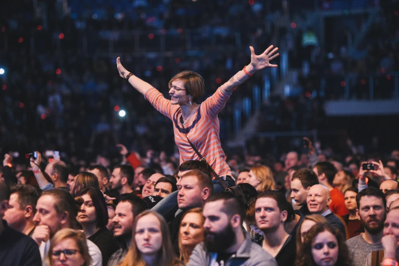 a woman sitting on top of her back surrounded by people