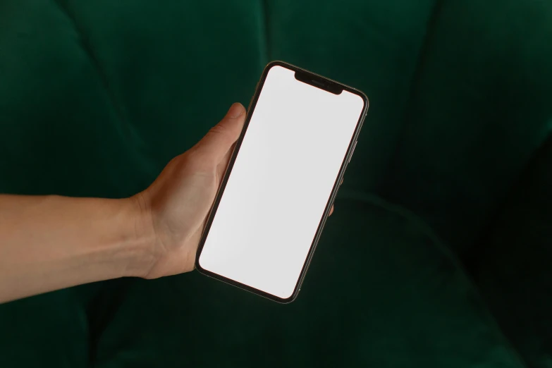 a hand holding a phone with a blank screen