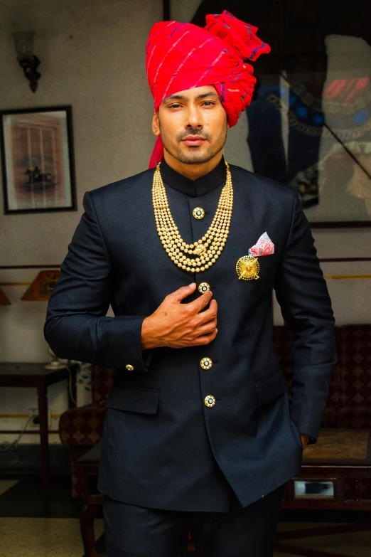 a man in turban and jacket posing for a picture