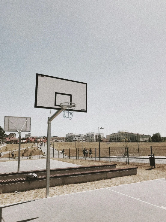an empty basketball court in a rural area