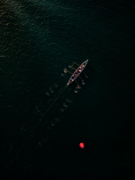 the overhead view of a ship with two men rowing