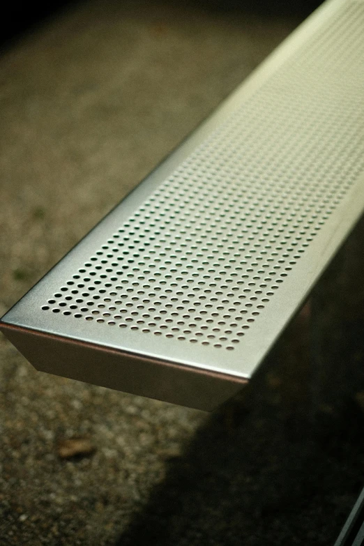 a table with perfored aluminum slats in front