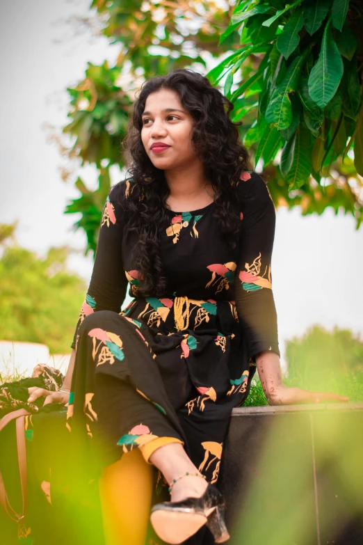 a woman sits on a bench outside