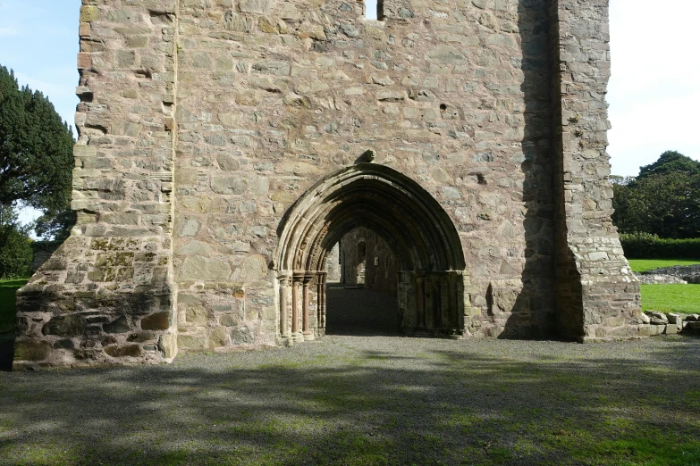 a tall stone building with a tall gate next to it
