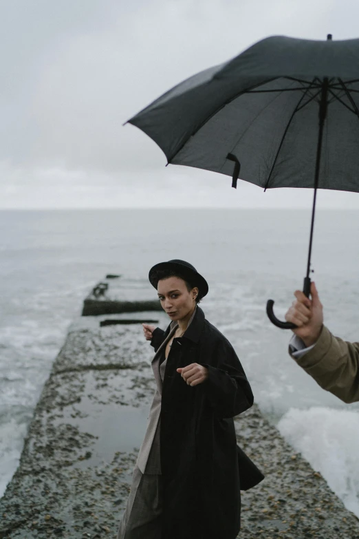 a person walking while holding an umbrella