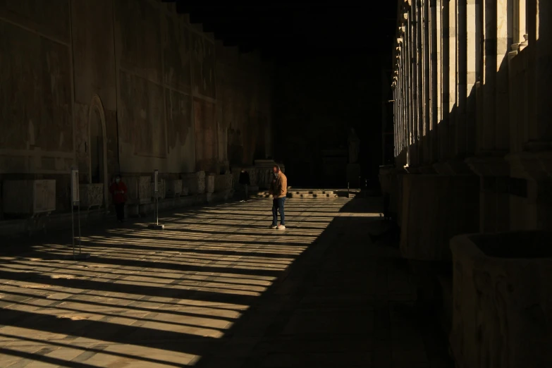 a man is walking in the sun at night