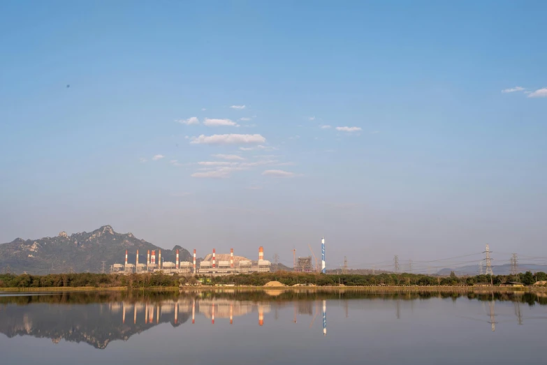 a small body of water sitting in front of a large hill